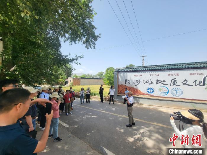 圖為中國地質(zhì)大學(xué)(北京)教授張緒教介紹村落情況。　胡友軍 攝