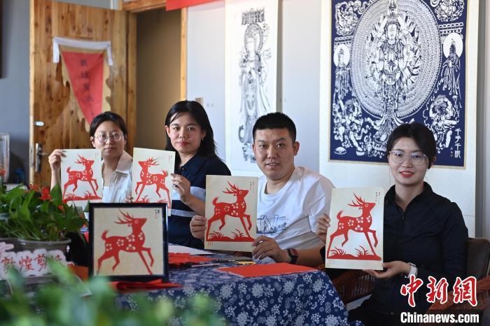 6月6日，在甘肅敦煌青年夜校課程中，青年學(xué)員展示學(xué)習(xí)敦煌非遺剪紙的成果。李亞龍 攝　　